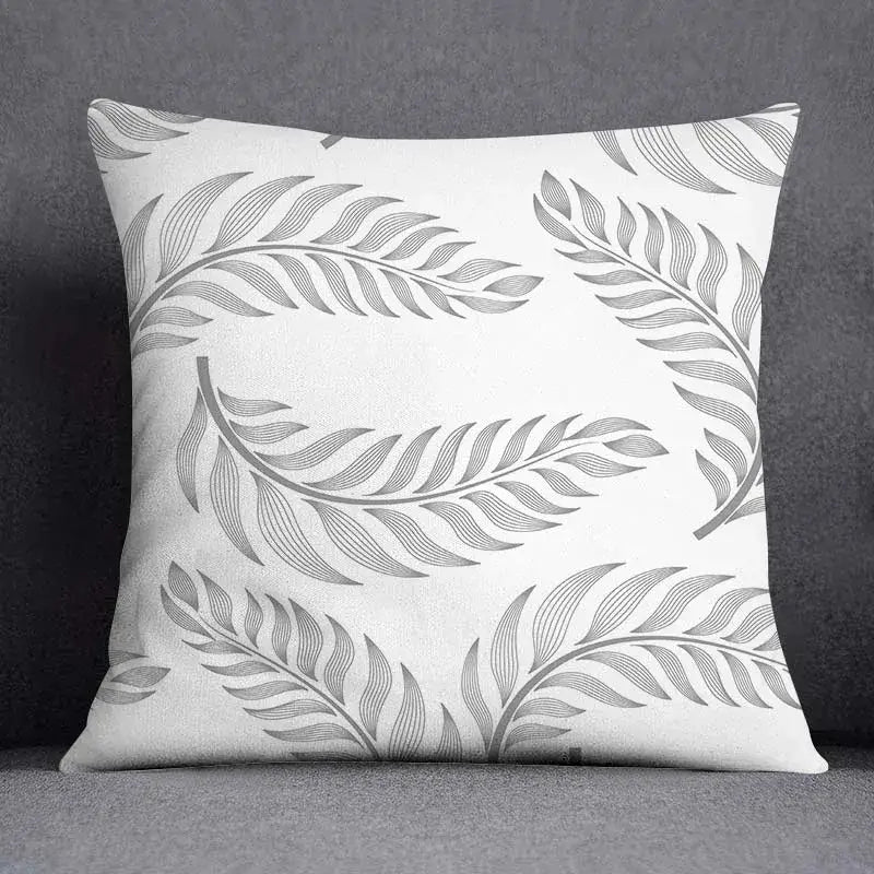 White throw pillow case with a geometric floral print of gray stylized fern leaves for living room decorbites decor