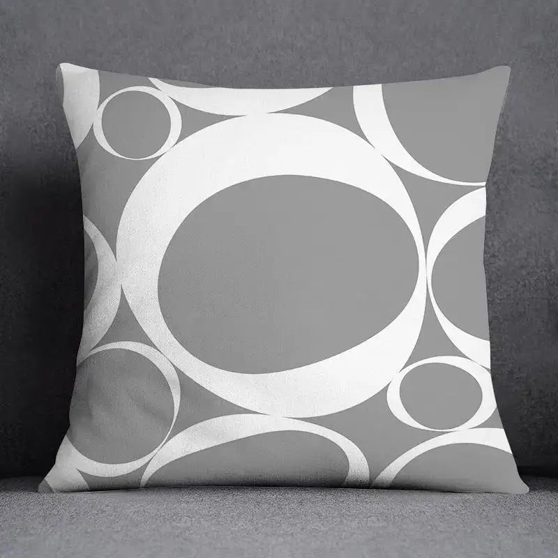 Gray throw pillow case with a decorbites geometric floral print of overlapping white and gray circles for living room decor