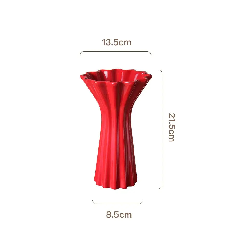 Vibrant red ceramic vase with geometric fold pattern and fluted petal-like rim decorated with twine for living room decor