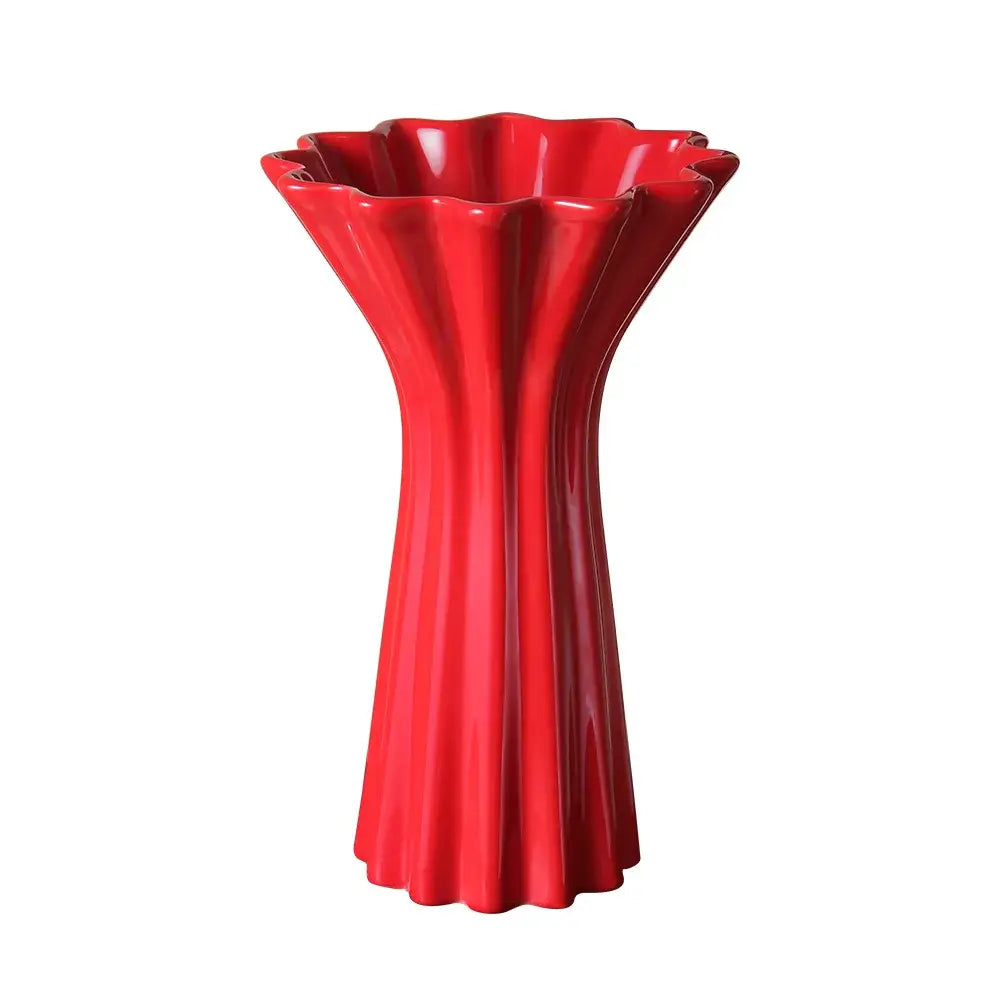 Vibrant red ceramic vase with geometric fold pattern and fluted petal-like rim for living room decor with twine