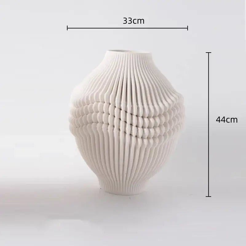 A sleek white geometric folding ceramic vase with ribbed wave-like texture for decorbites living room decor