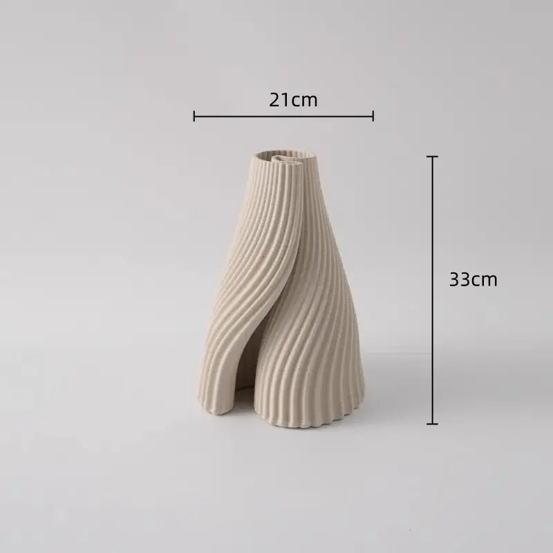 Beige ceramic vase with sculpted ribbed design and asymmetrical twisted form for decorbites geometric folding decor