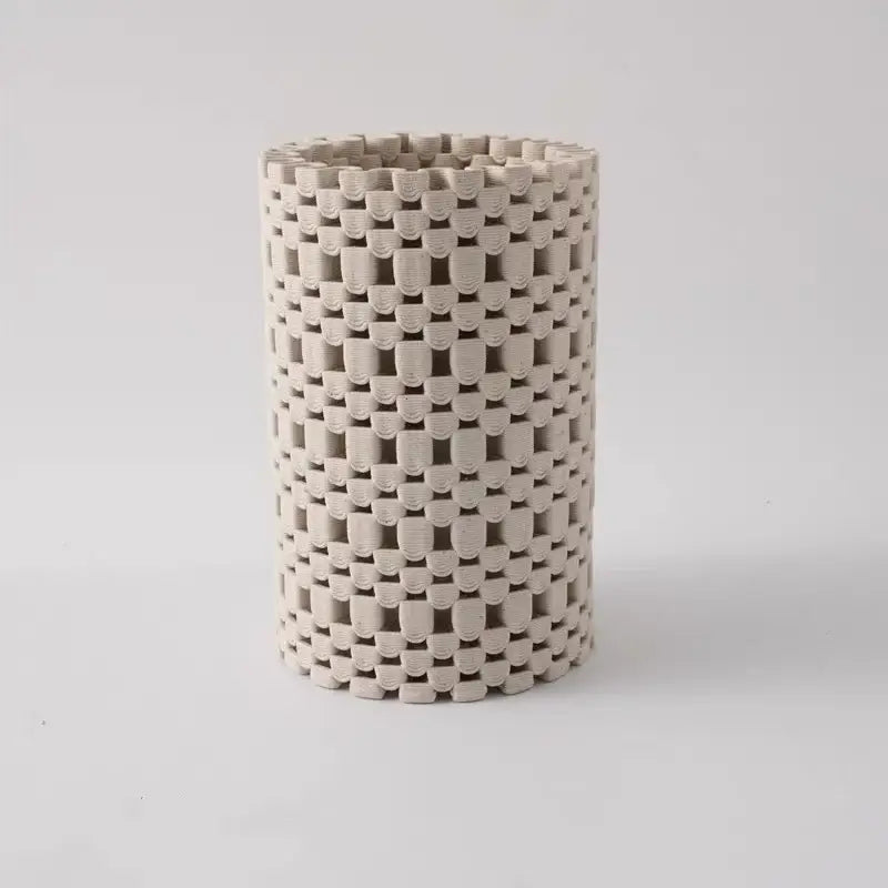 Beige ceramic cylindrical vase with a woven interlocking geometric folding pattern for living room decorbites decor