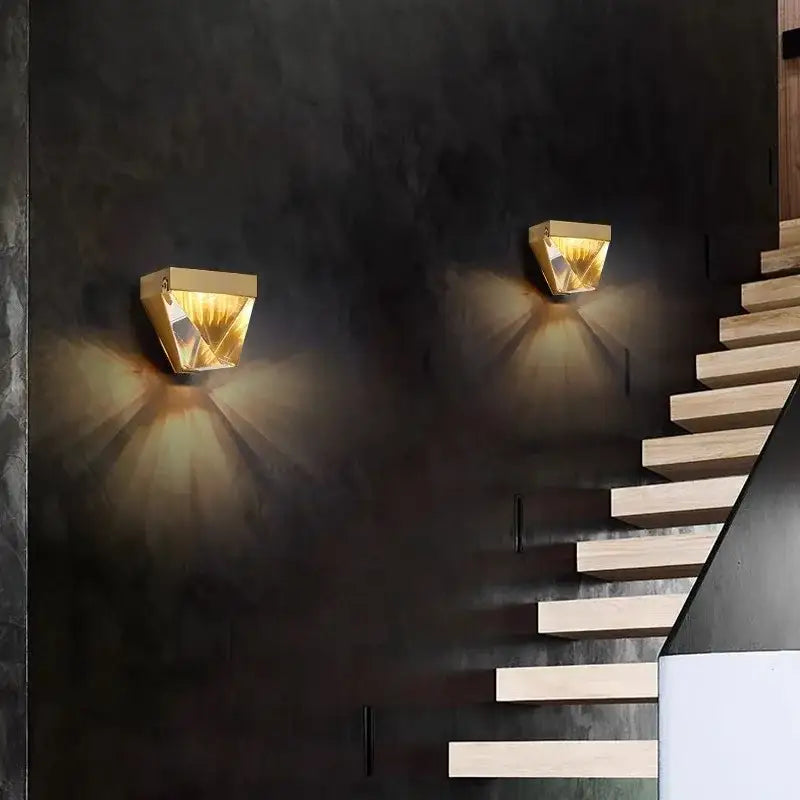 Geometric gold crystal led wall sconce with faceted crystal surfaces casting warm light for bedroom decorbites crystal led