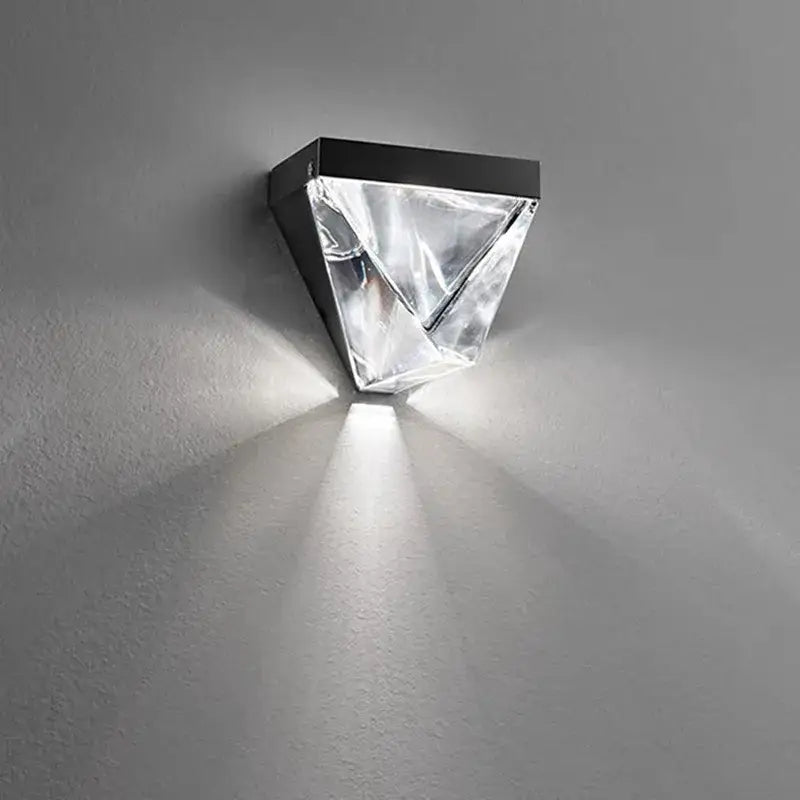 Modern black-framed led wall sconce with a faceted crystal acrylic diffuser casting focused light for decorbites crystal led use