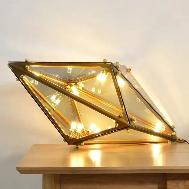 Geometric gold brass-framed led pendant lights with clear glass panels and warm interior lighting for dining room
