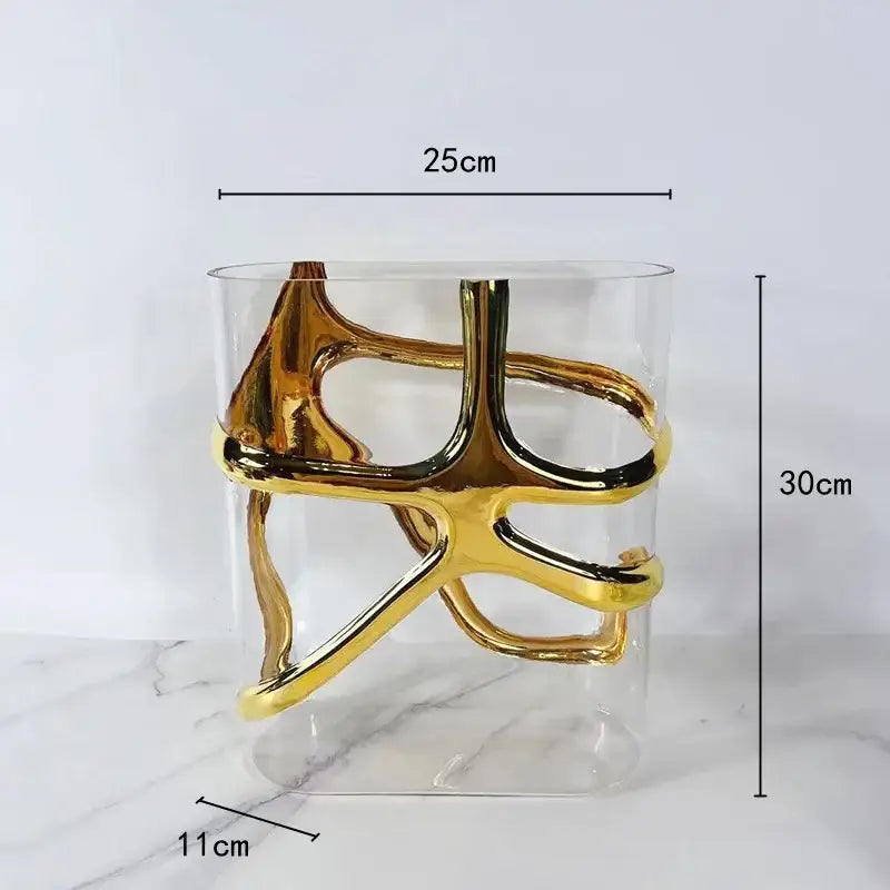 A modern transparent glass vase with an intricate gold-edged glass sculpture for living room decorbites decor