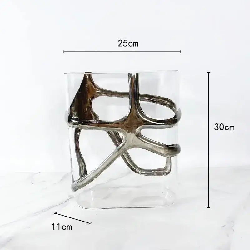 A modern glass vase with a sleek silver metallic abstract sculpture and gold edges for living room decorbites decor