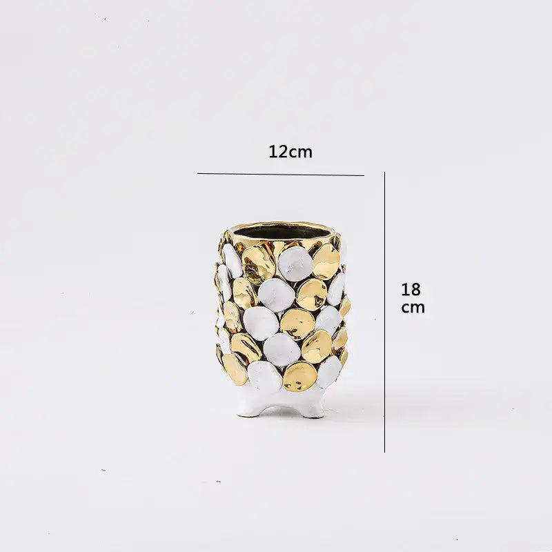 Decorative geometric gold leaf relief ceramic vase with textured white and gold discs standing 18 cm tall