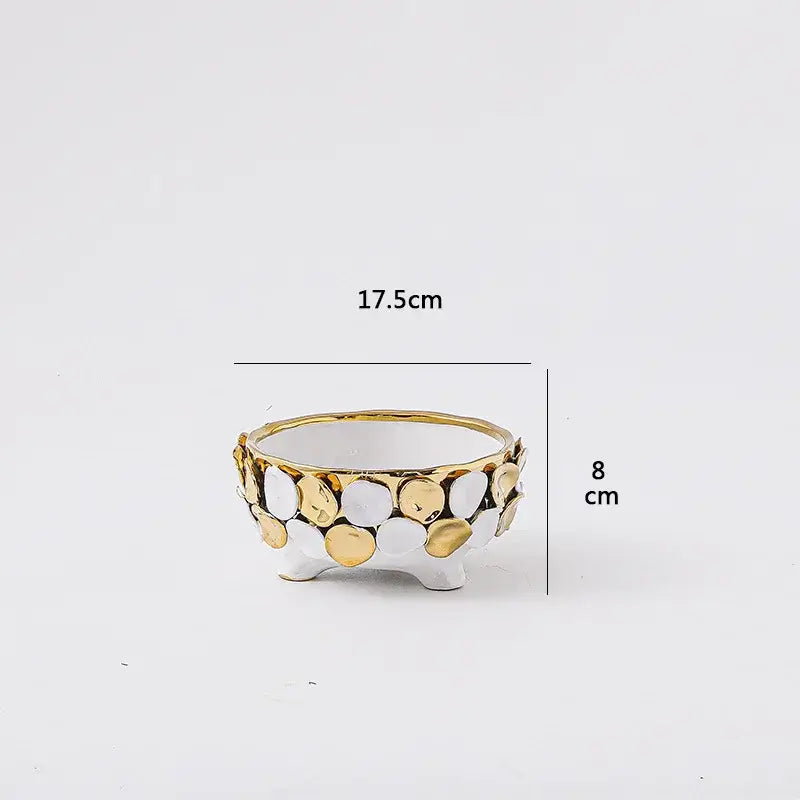 A white ceramic planter with geometric gold leaf relief and gold and silver circular embellishments for living room decor