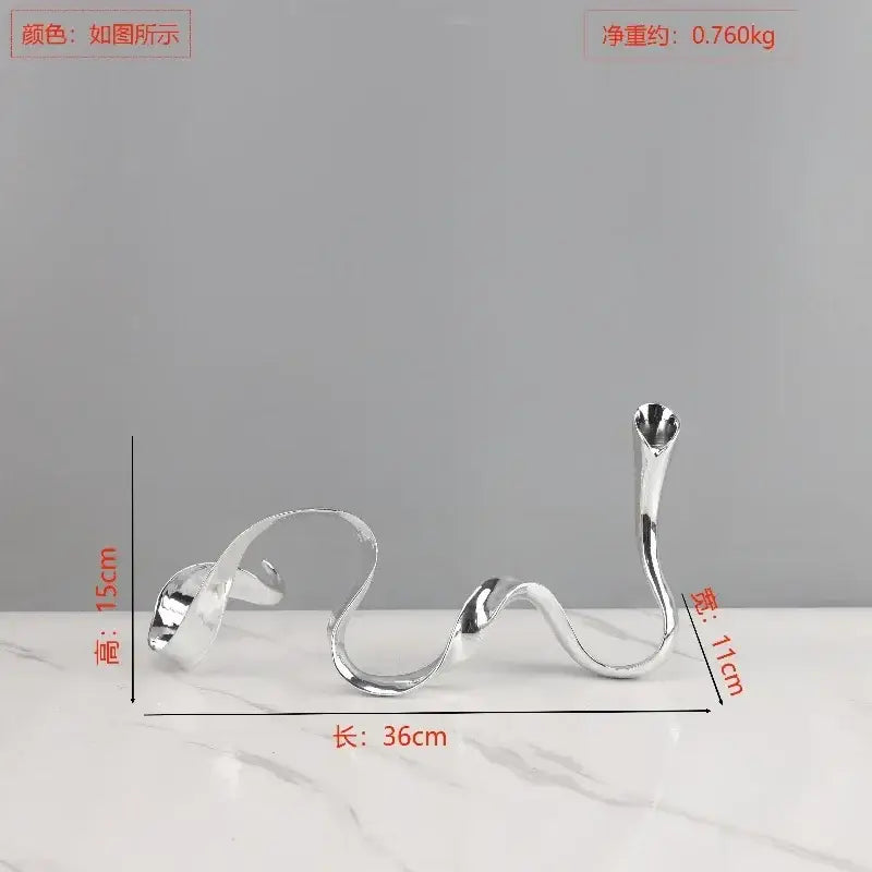Silver sleekly curved metal candlestick holder with a modern abstract design for decorbites geometric gold dining room centerpiece