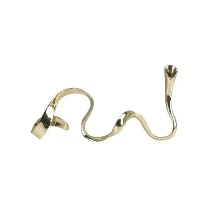 A sleek gold-toned metal ring with a wave-like design for decorbites geometric gold candlestick dining room centerpiece