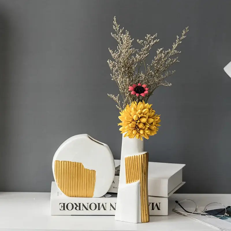 White ceramic vase with geometric gold striped design holding dried flowers for living room hydroponics