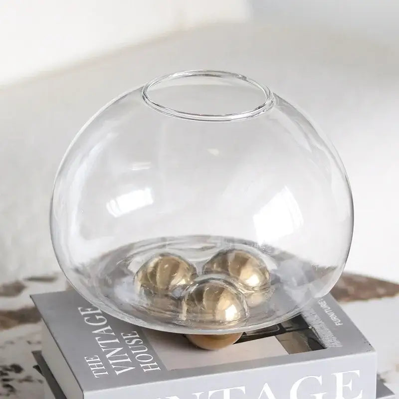Clear glass spherical vase with three golden ball metal spheres inside for decorbites geometric golden ball decor