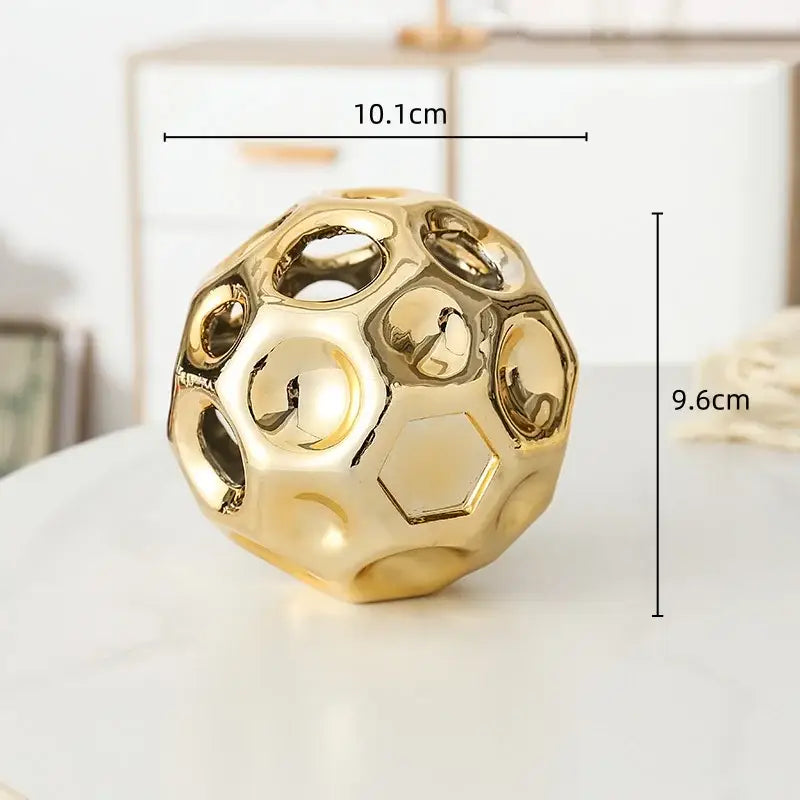 Golden hollow ceramic decorative sphere with geometric honeycomb pattern for living room decorbites geometric golden hollow decor