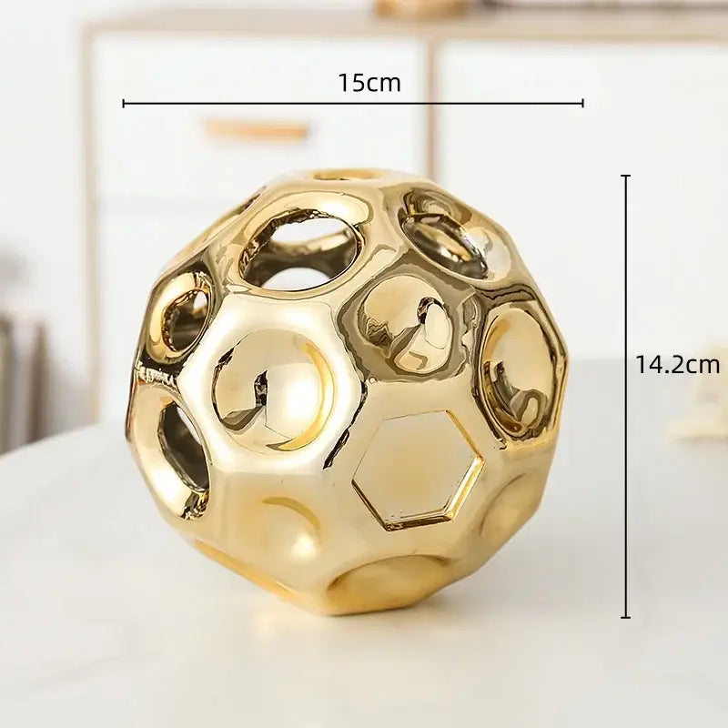 Golden hollow ceramic decorative sphere with geometric honeycomb pattern for decorbites geometric golden hollow decor