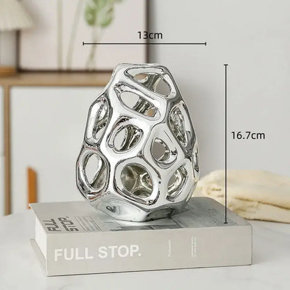 Shiny silver ceramic sculpture with geometric honeycomb design for decorbites geometric golden hollow living room decor