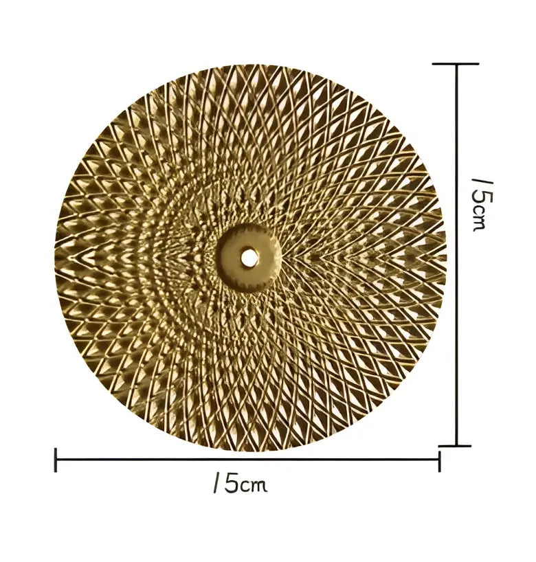 Decorbites geometric golden metal wall art featuring a round gold-colored disc with textured diamond pattern and central hole