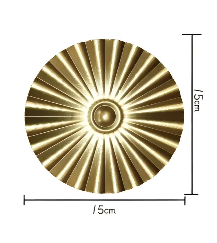 A 15cm diameter brass-colored circular decorative plate with sunburst design from decorbites geometric golden metal wall art set