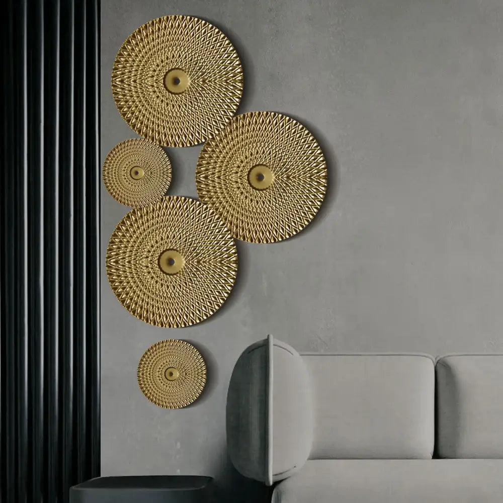 Geometric golden metal wall art featuring gold-colored circular design with textured diamond pattern and central embellishments