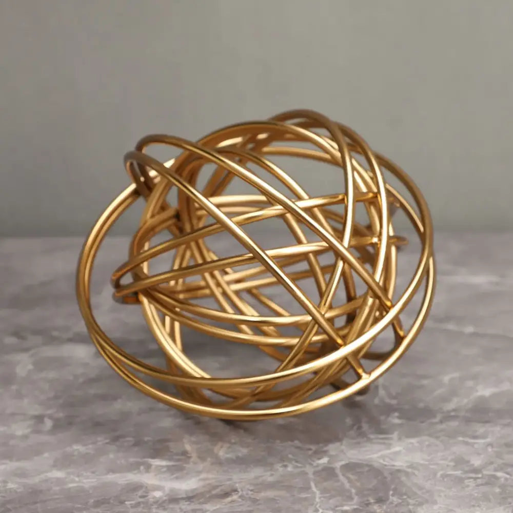 Golden wire sphere decorative figurines with interwoven circular bands featuring decorbites geometric golden thread design