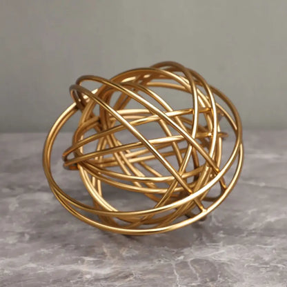 Golden wire sphere decorative figurines with interwoven circular bands featuring decorbites geometric golden thread design
