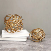 Golden wire decorative figurines with intertwined circular loops metal balls featured in decorbites geometric golden collection