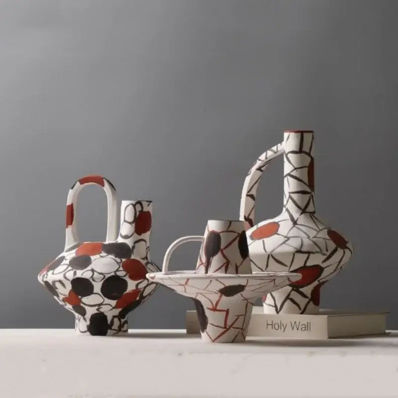White ceramic geometric graffiti vase with bold black and rust red abstract pattern for terracotta decorbites decor