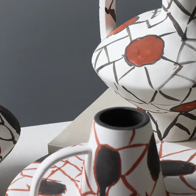 White ceramic pitcher with bold black and rust orange geometric graffiti ceramic design for terracotta decorbites decor