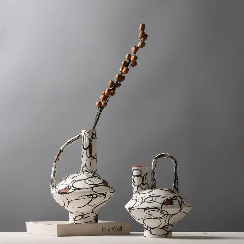 White ceramic geometric graffiti vases with black and terracotta abstract patterns for modern living room decor
