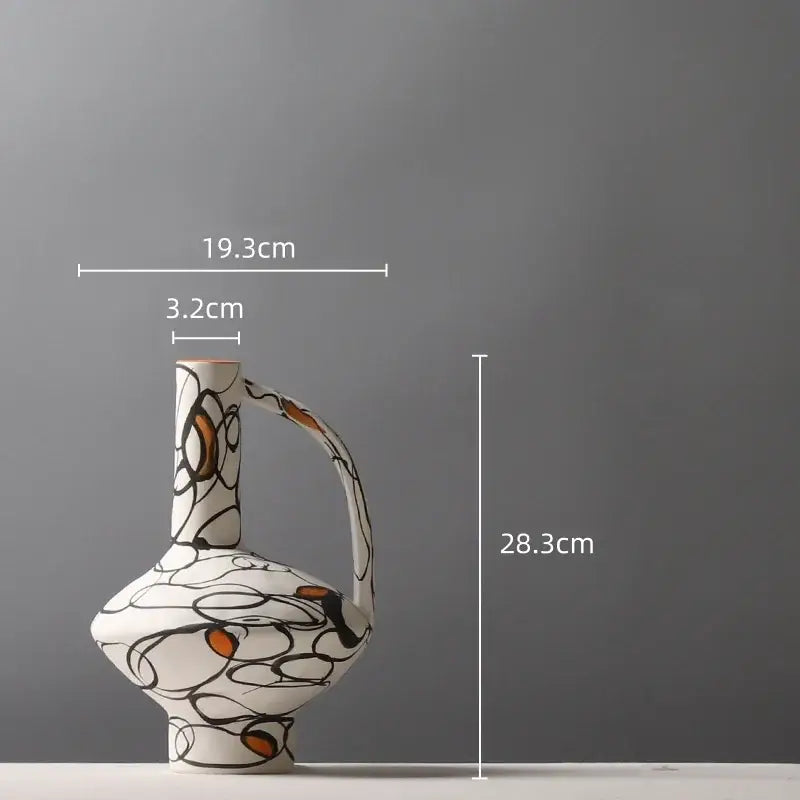 A white ceramic geometric graffiti vase with slender neck curved handle and terracotta black and orange patterns for decorbites living room decor