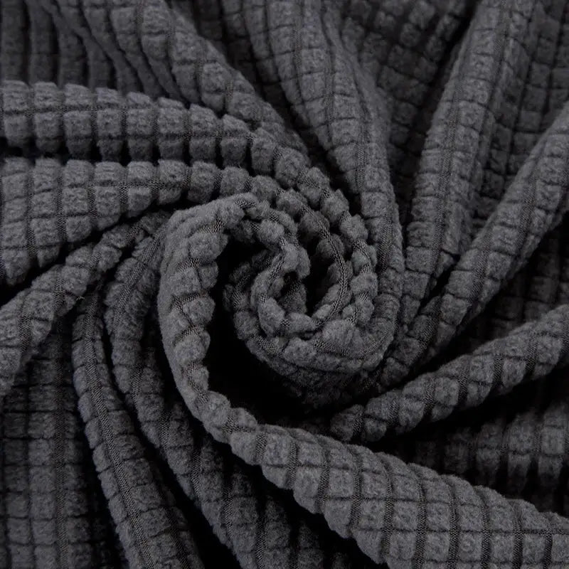 Dark gray corduroy sofa cover with a geometric waffle texture and pillow for living room stretch use