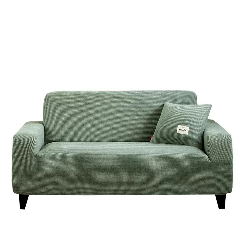 Geometric gray textured stretch sofa cover with sage green woven fabric and matching pillow for living room use