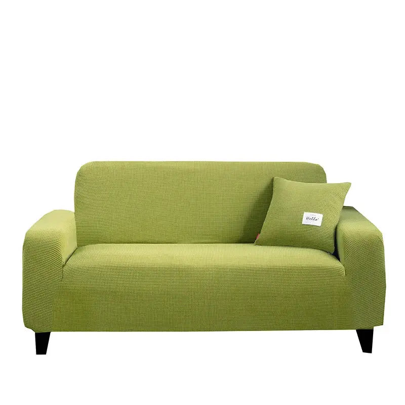 Green textured fabric sofa cover with matching pillow complementing geometric gray textured stretch sofa cover for living room