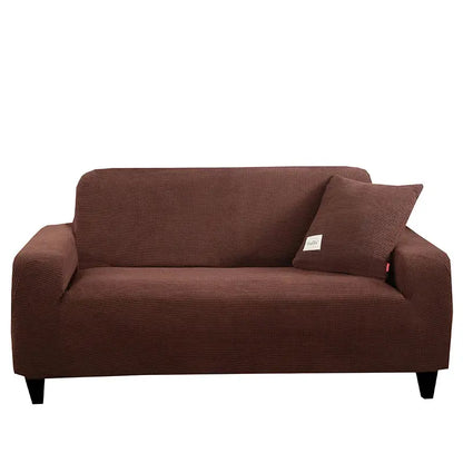 Brown textured stretch sofa cover with matching pillow for living room use featuring geometric gray design