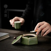 Geometric green ceramic ashtray with lid featuring a dark brown knob ideal for office desk decorbites geometric green decor