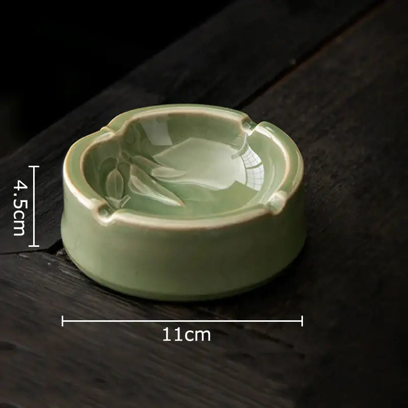 Delicate light green geometric green ceramic ashtray with subtle leaf design and four cigarette indentations for decorbites office desk decor