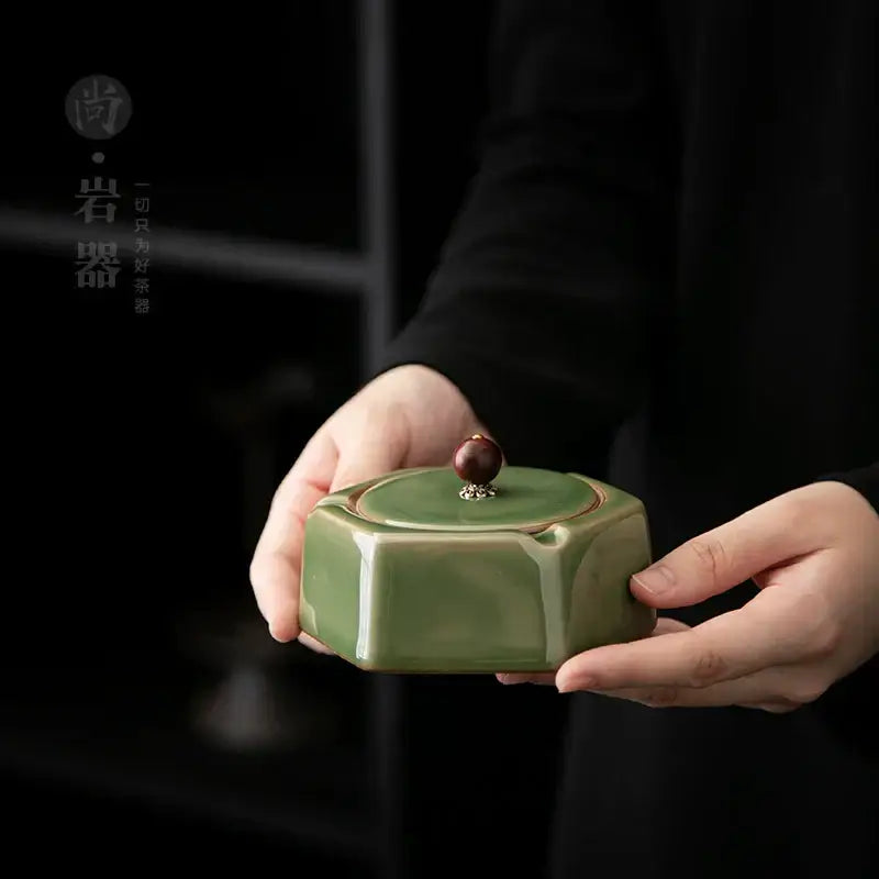 Geometric green ceramic ashtray with lid featuring a sleek hexagonal shape and glossy sage green decorbites geometric green glaze