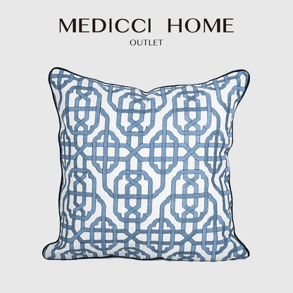 Blue geometric patterned pillow cover from Medicci Home Outlet featuring white embroidered details for living room decor