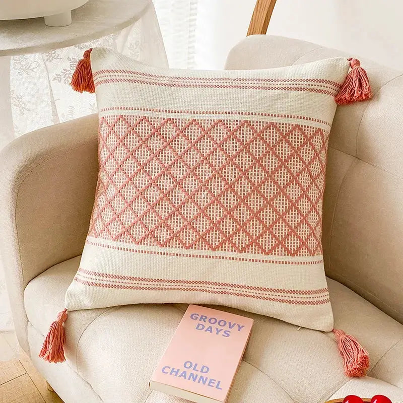 Cream-colored cushion cover with terracotta pink woven geometric pattern and tassels for decorbites blue diamond decor