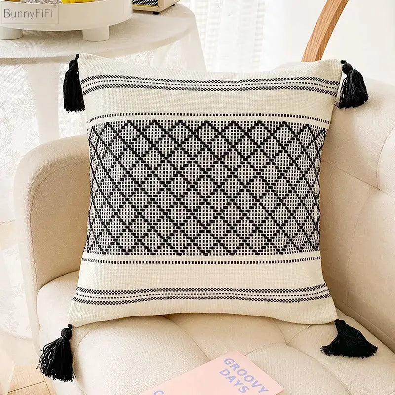Cream-colored cushion cover with black geometric embroidery and tassels featuring decorbites blue diamond jacquard design