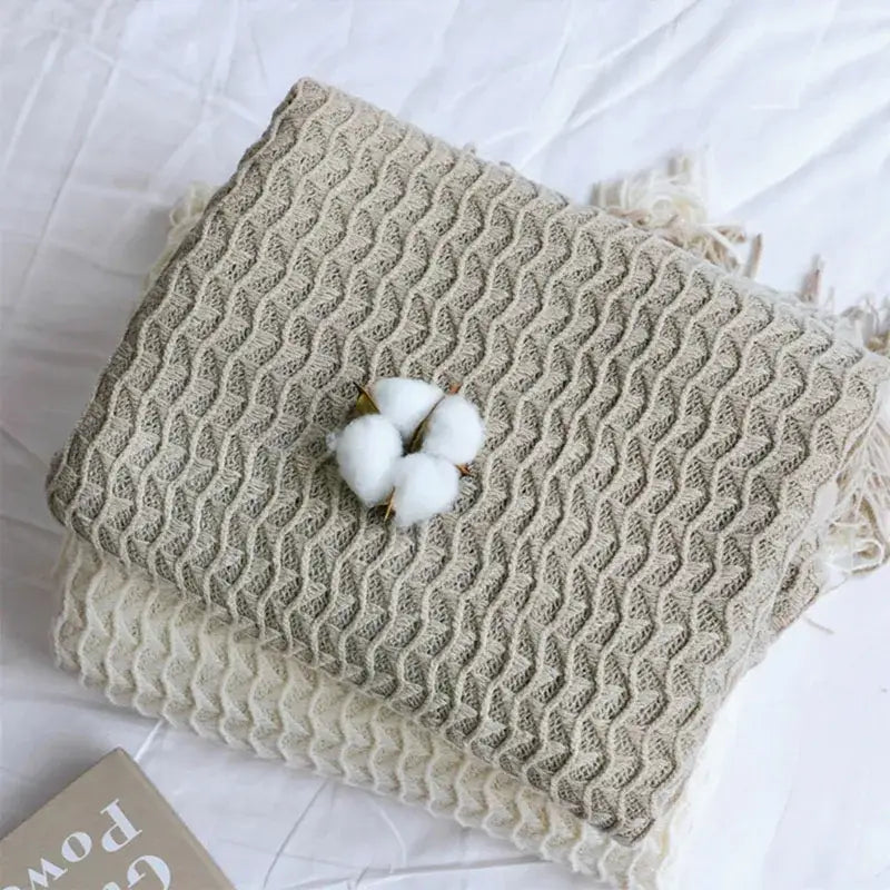 Beige knitted geometric knit sofa blanket with wavy texture fringe edges and cotton boll accent for decorbites knit sofa blanket