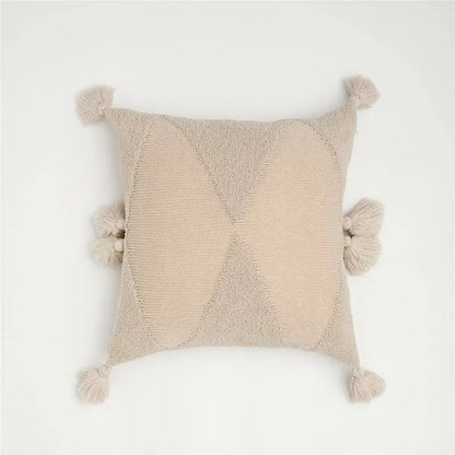 Beige knit cushion cover with textured diamond pattern and fluffy tassels suitable for decorbites knitted mustard blue decor
