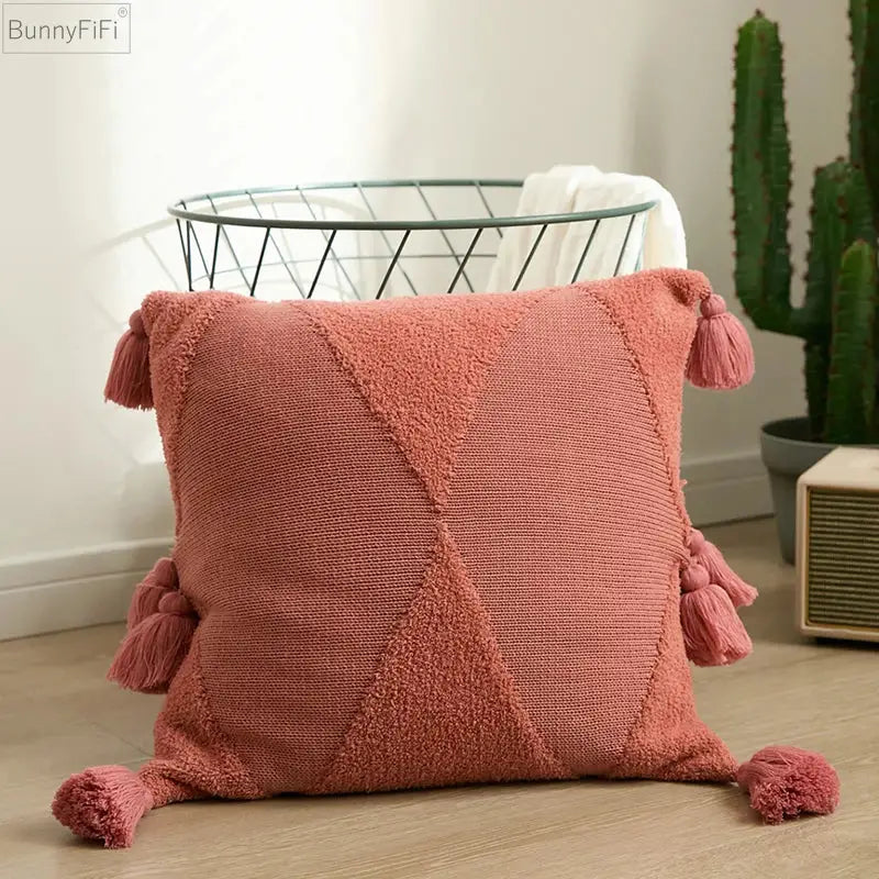 A soft dusty rose knitted throw pillow with tassels complements decorbites knitted mustard blue cushion cover decor