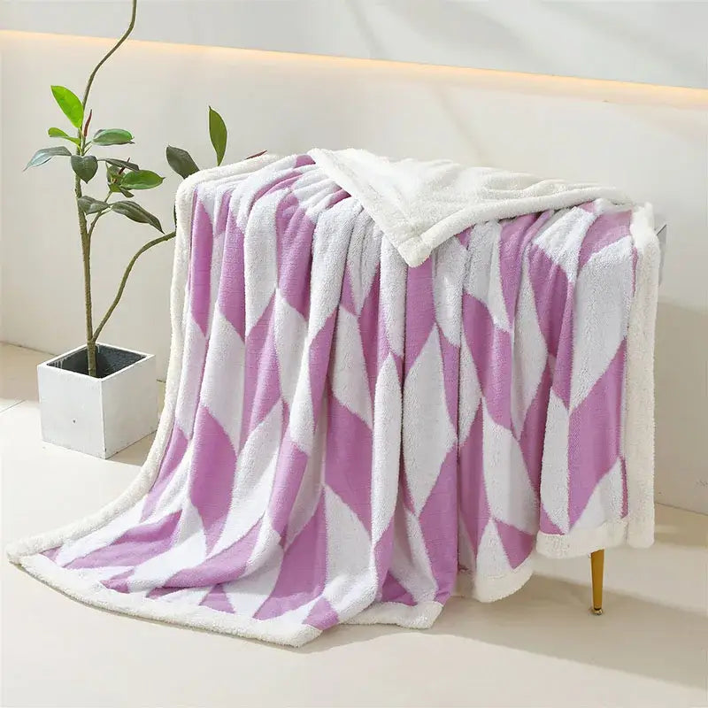 A plush geometric lamb wool blanket with lavender and white diamond pattern and white sherpa lining for cozy decorbites decor