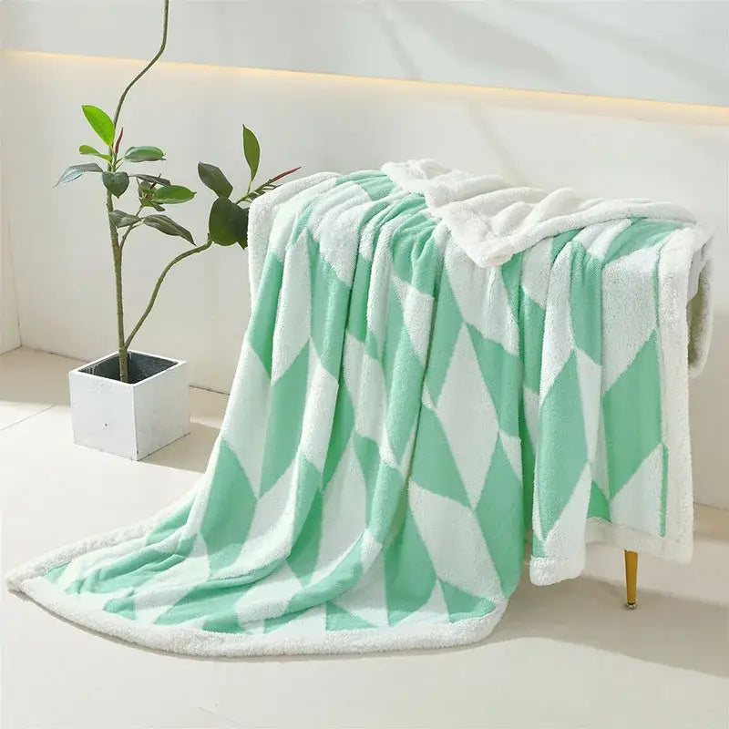 A soft mint green and white geometric lamb wool blanket with plush sherpa lining for cozy bedroom decorbites geometric lamb throw