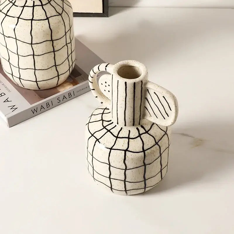 Cream-colored geometric line ceramic vase with black grid pattern and handle ideal for living room decorbites decor