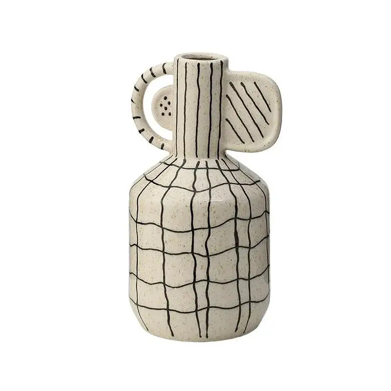 Cream-colored geometric line ceramic vase with black hand-painted grid and abstract handle for decorbites decorbites geometric line