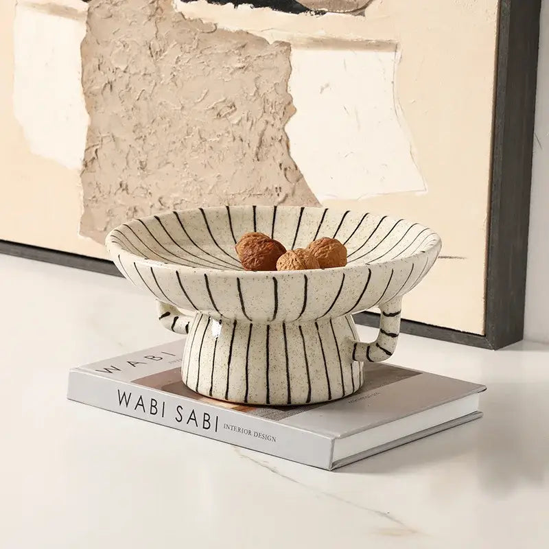 A cream-colored geometric line ceramic vase with black stripes and handles, perfect for living room decorbites decor