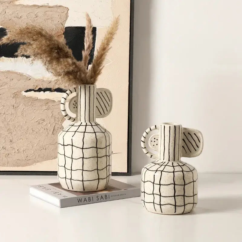 Cream-colored geometric line ceramic vase with black grid pattern and decorative ear-like handles for living room decorbites